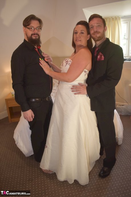 Amateur woman Sara Banks as her tits and pussy freed from a gown by two men