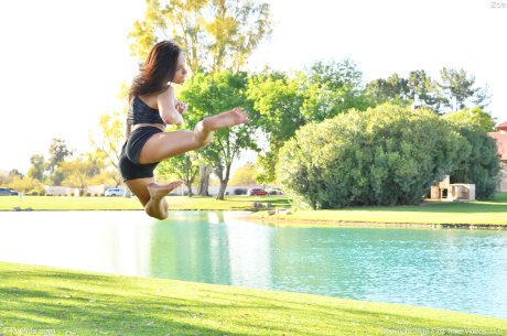 Teenage hottie in sexy outfit Zoe doing exercise outdoors by the water