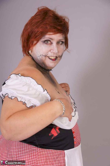 Redheaded BBW Lexie Cummings doffs cosplay wear to pose nude in mesh nylons