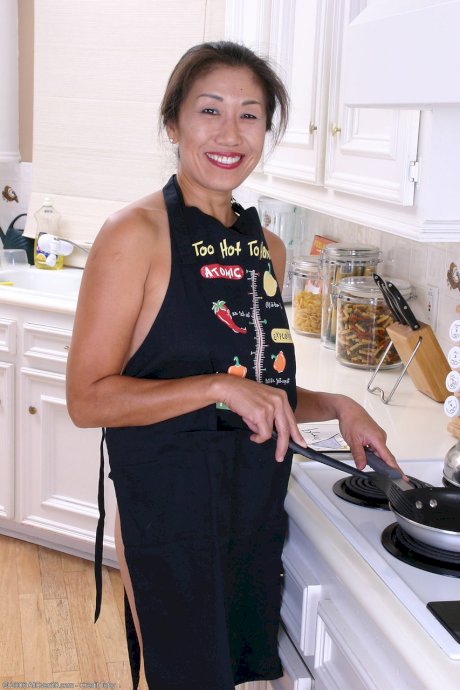 Charming Asian housewife Nina loses her apron and shows her twat & big ass