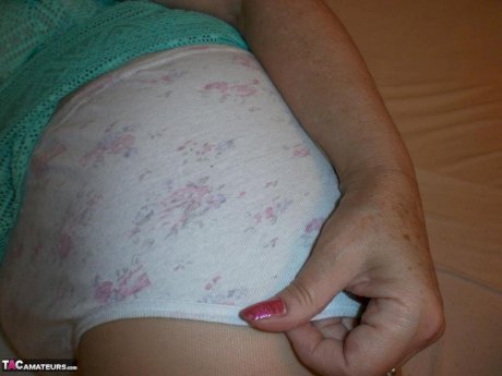 Hairy grandmother slides her upskirt panties aside to expose her vagina