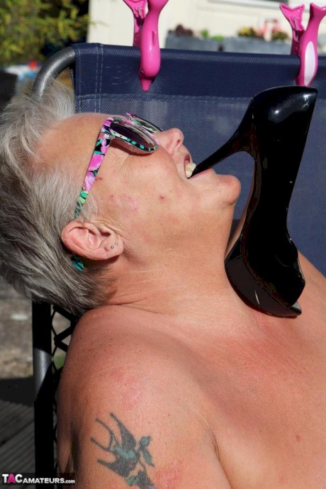 Fat nan Valgasmic Exposed licks a shoe while exposing herself in the backyard