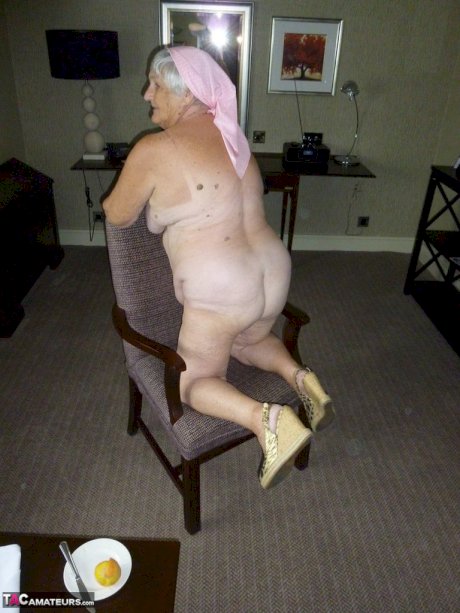 Obese grandmother licks her own nipples as she strips naked in living room