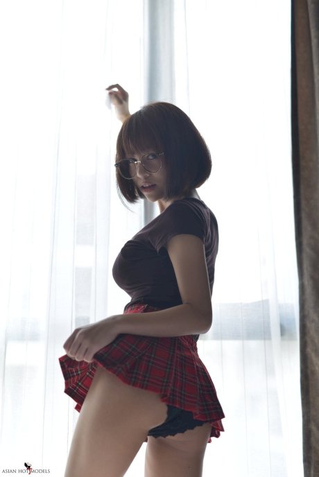 Pretty Asian teen flaunts her hot ass wearing a miniskirt and panties
