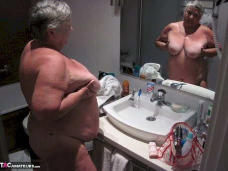 Obese amateur Grandma Libby blow drys her hair after taking a shower