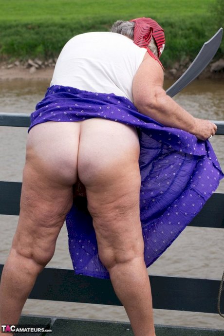 Fat British granny exposes herself on a bridge while sporting pirate attire