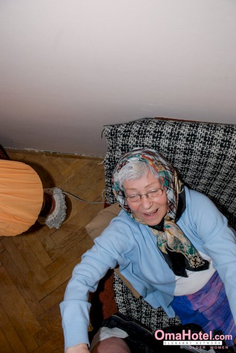 Cute granny with glasses Agnes strips and massages a nice fat dick