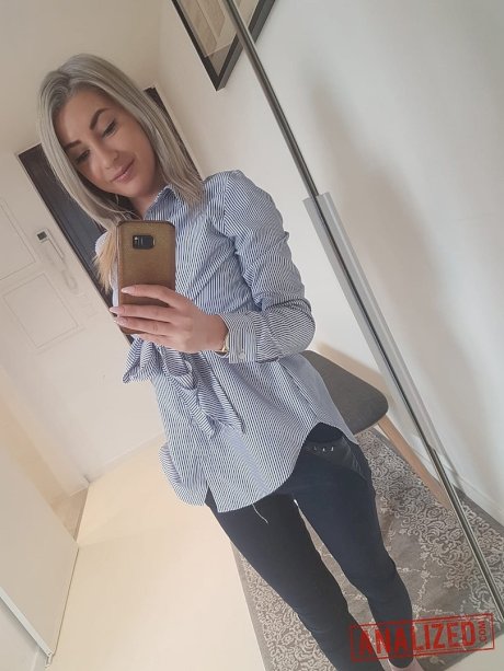 Amateur blonde Ari Fox reveals her small boobs and poses in front of a camera