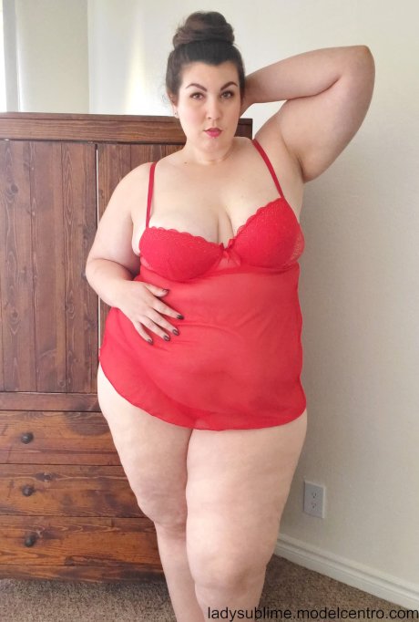 Fatty in a red negligee Lady Sublime flaunts her big juggs while sucking a toy