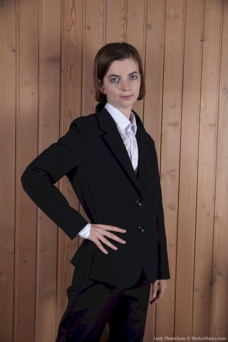 Sexy Lady Phanthom takes off her black suit to show her hairy pussy up close