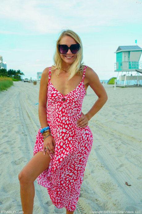 Skinny blonde Ally gets totally naked on a public beach in sunglasses