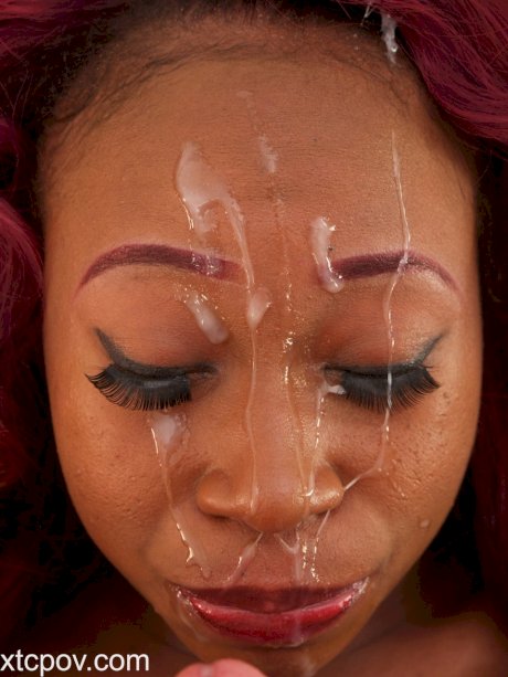 Curly haired redheaded ebony gets her face covered with jizz after a blowjob