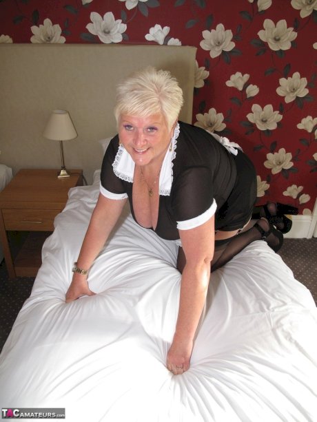 Fat mature maid serves her guests while wearing revealing clothing