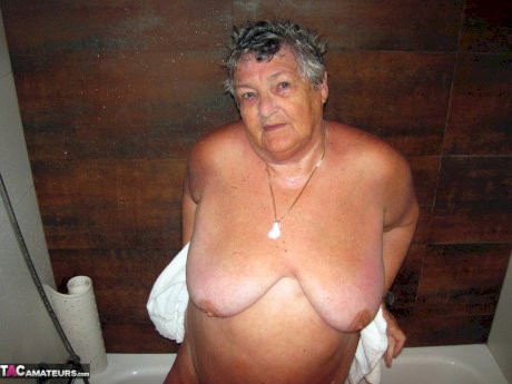 Obese amateur Grandma Libby blow drys her hair after taking a shower