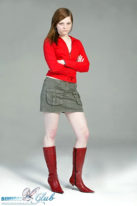 Pale redhead Lilly slowly strips to a black G-string and red leather boots