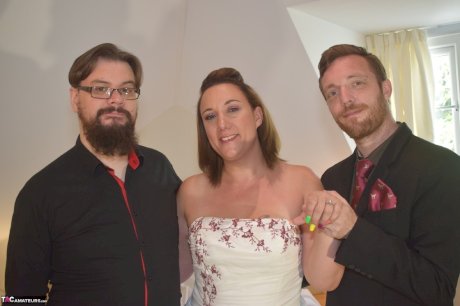 Amateur woman Sara Banks as her tits and pussy freed from a gown by two men