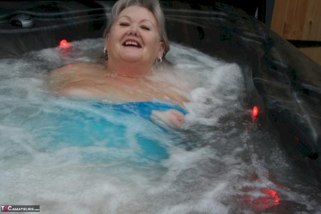 Old woman Valgasmic Exposed plays with her breasts while hot tubbing