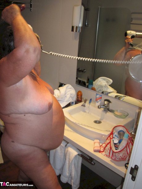 Obese amateur Grandma Libby blow drys her hair after taking a shower