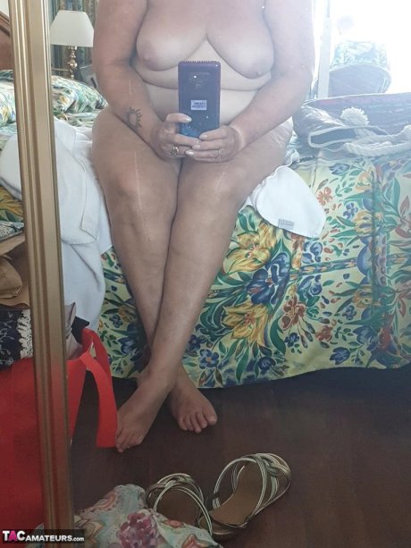 Fat granny with red hair Valgasmic Exposed takes naked selfies at home
