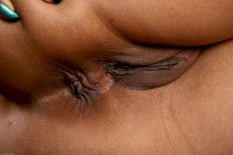 Short haired black woman with pierced nipples tries her hand at nude modeling