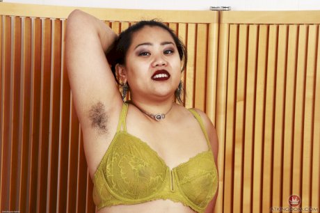Chubby Asian female Manila Bey exposes her big tits and hairy pussy