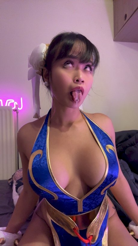 Brunette only fans babe Asian Eye teases with her big cleavage in a hot outfit