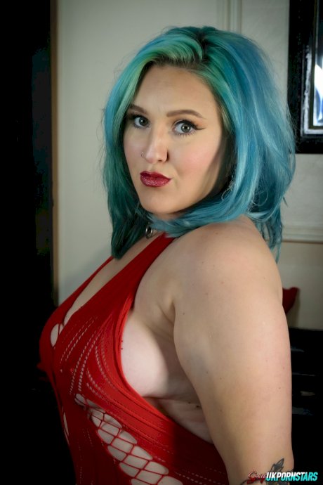 UK pornstar Ruby Fall lets her nipples slip free from a revealing red dress