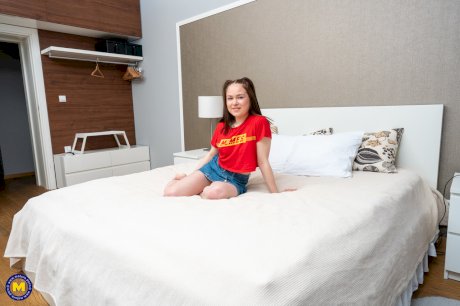 Fat matures and a petite teen show their tits and pose on a bed