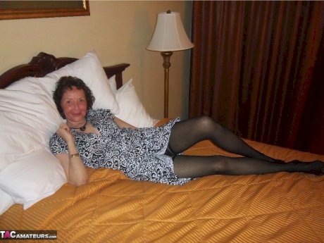Curly haired mature woman likes sending her younger partner provocative photos