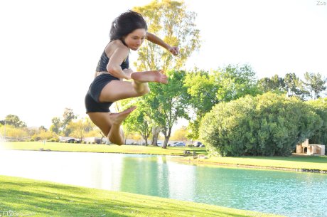 Teenage hottie in sexy outfit Zoe doing exercise outdoors by the water