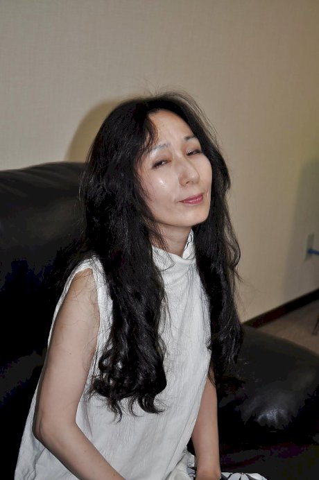 Asian mature lassie Nobue Toyoshima stripping and teasing her hairy twat