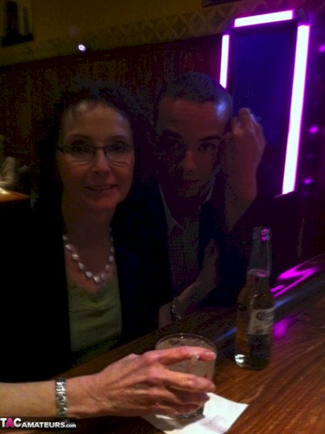 Curly haired mature woman likes sending her younger partner provocative photos