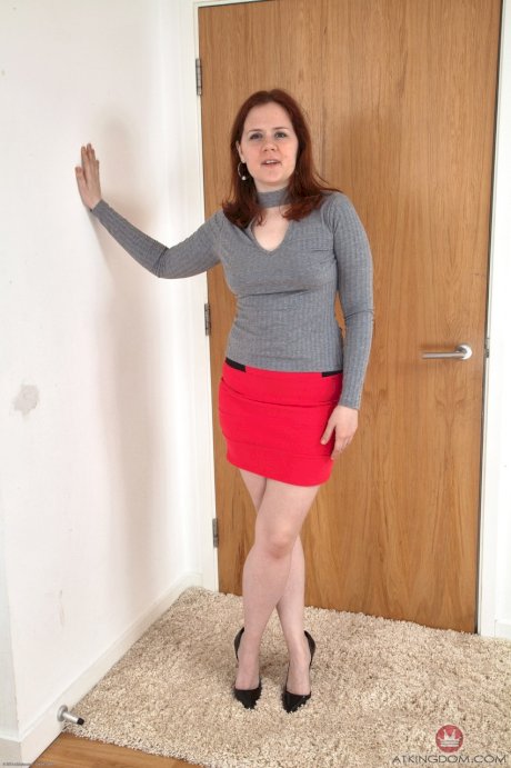 Luscious lady Kathy sitting on the carpet spreading her furry vagina