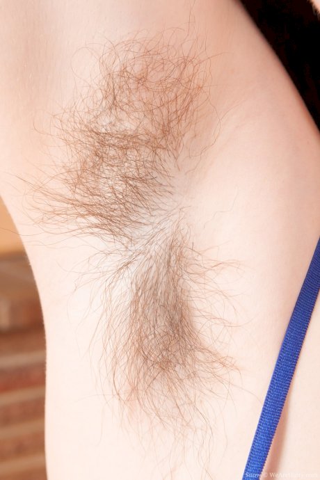 Cute brunette teen Snow reveals her big tits and hairy twat in a solo
