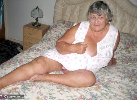 Old woman Grandma Libby grabs her fat roll after getting naked on a bed