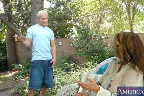 Big titted cougar Lisa Lipps has sex with a young man in her backyard garden