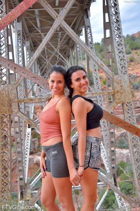 Amateur babe Saraya strips and poses naked with her busty friend in public