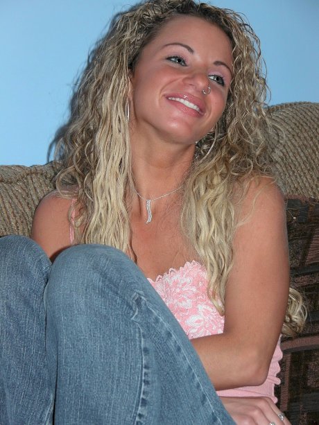 Slender curly-haired MILF Holly toys her tight love hole up close on the sofa