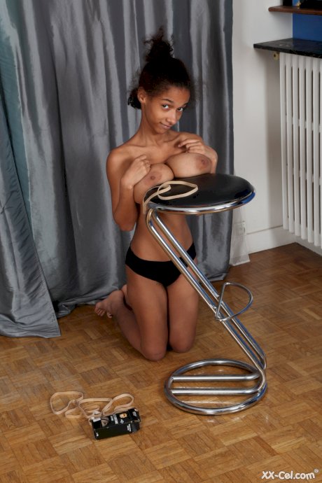 Ebony Addisson shows off her huge breasts and squeezes them in undies