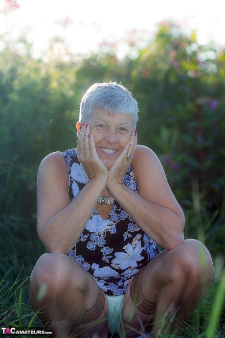 Silver haired granny Savana gets naked outdoors on a blanket in stockings