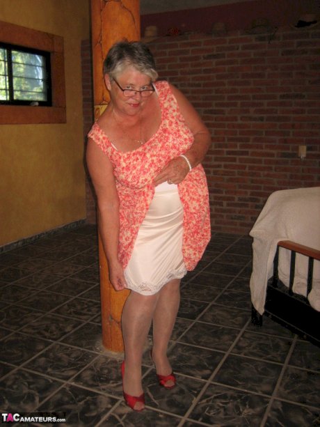 Fat granny Girdle Goddess holds her saggy tits in her hands by a pillar