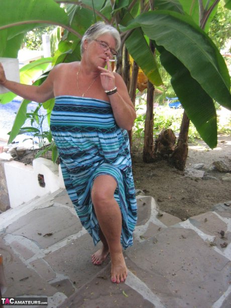 Old woman Girdle Goddess smokes before exposing her fat body on her patio