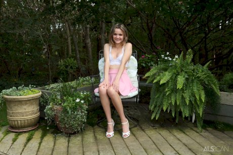 Teen cutie Addee Kate pleasures her pussy on a chair out on a wooden deck
