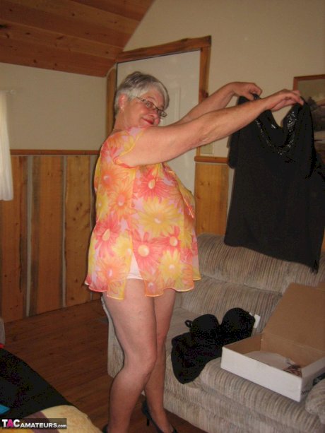 Obese granny Girdle Goddess wakes up from a nap and precedes to strip naked
