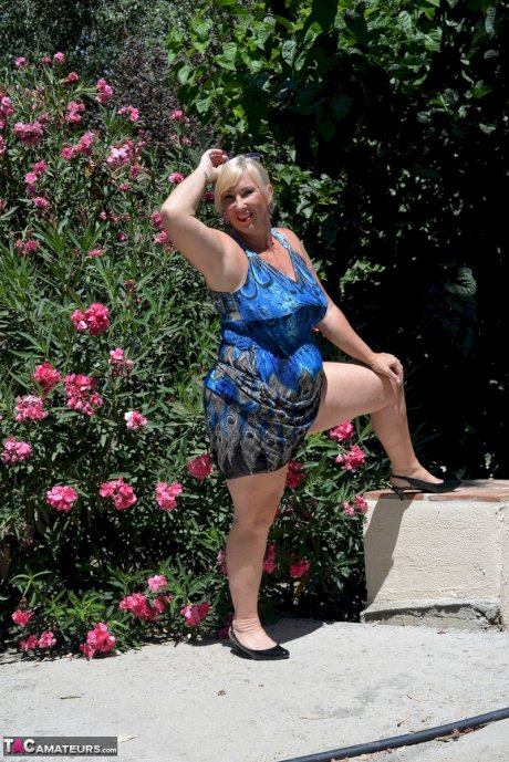 Mature blonde fatty Melody takes off her dress to pose in her underthings