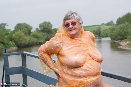 Obese oma Grandma Libby doffs a see-through raincoat to get naked on a bridge