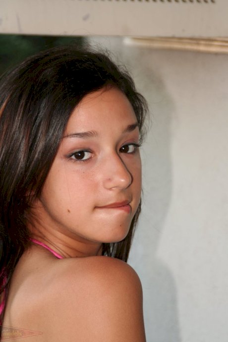 Young looking brunette Summer ditches satin lingerie to model naked