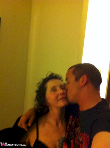 Curly haired mature woman likes sending her younger partner provocative photos