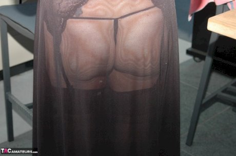 Mature blonde shows her pussy while wearing crotchless underwear in nylons