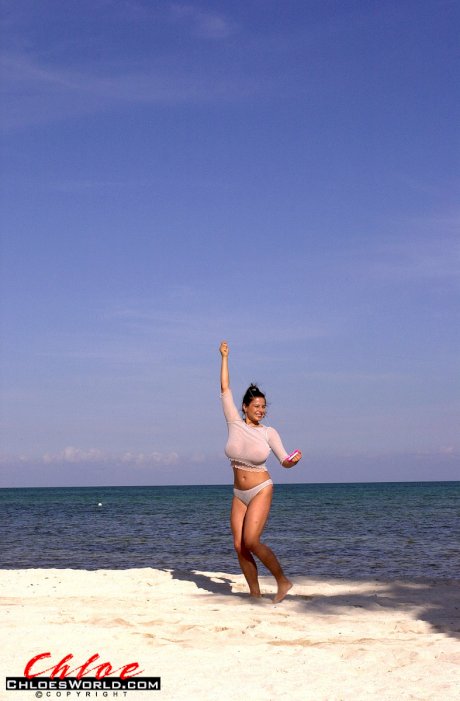 Super busty Chloe Vevrier letting her massive big tits hang loose at the beach
